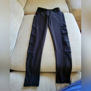 Womens small Black leggings by gottex, with cut out mesh squares on legs